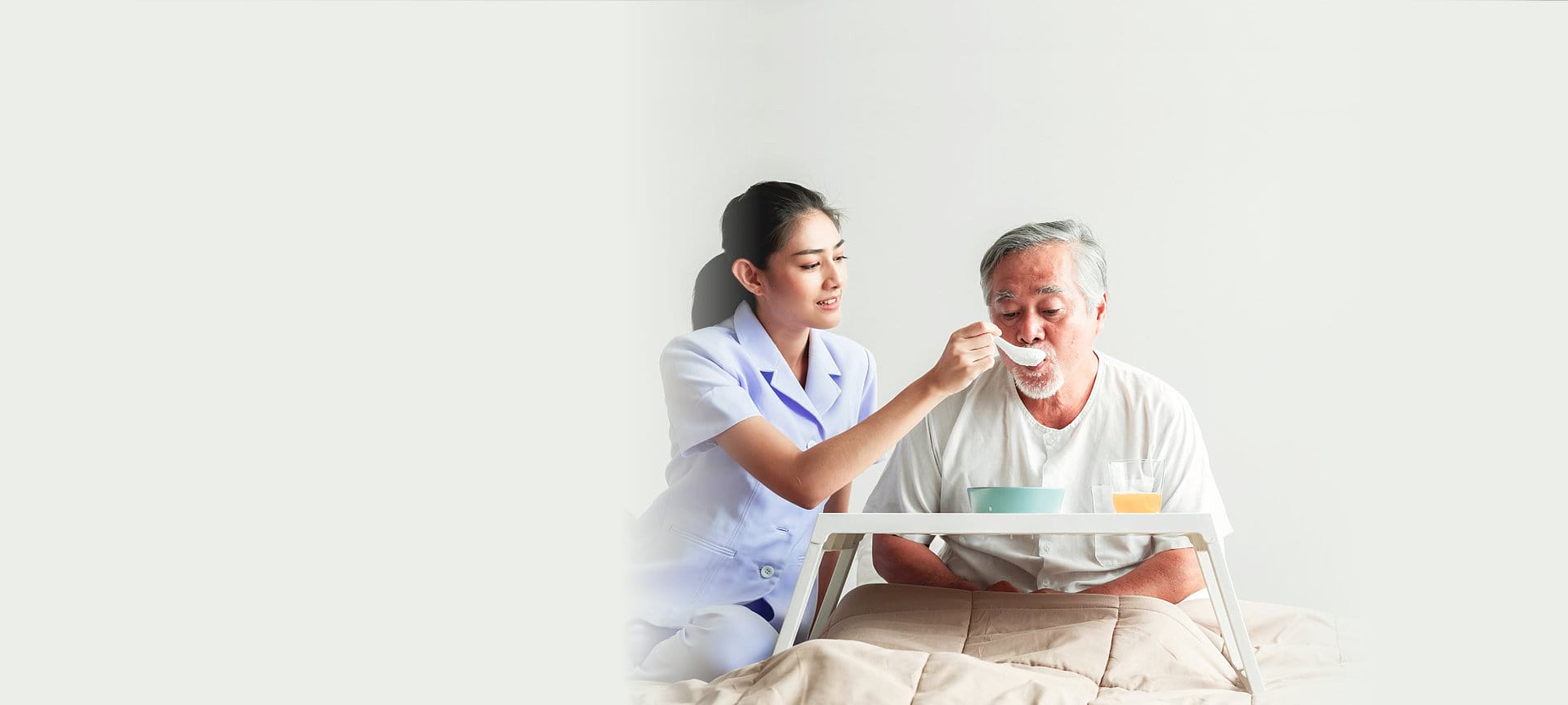caregiver helping patient to eat